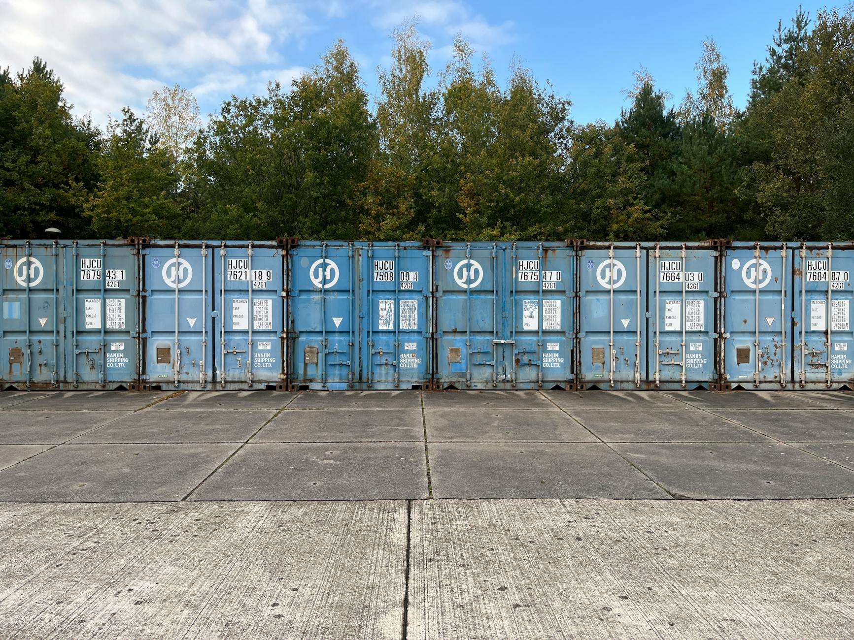 Secure blue shipping containers in an outdoor yard