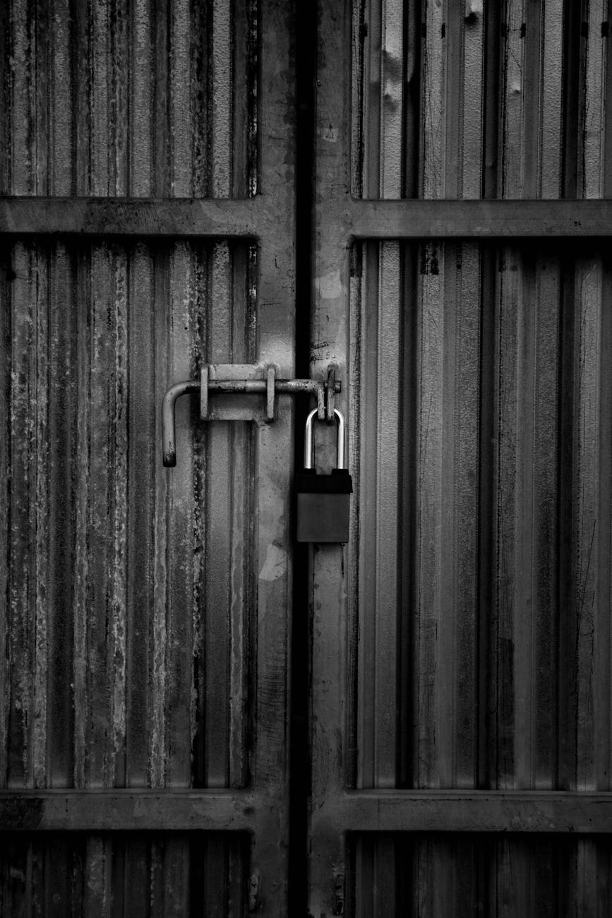 Heavy duty steel padlock on a corrugated steel door